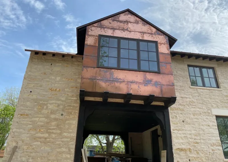 Copper metal panel facade on a stone building for Skylight Installation in Cedar Falls